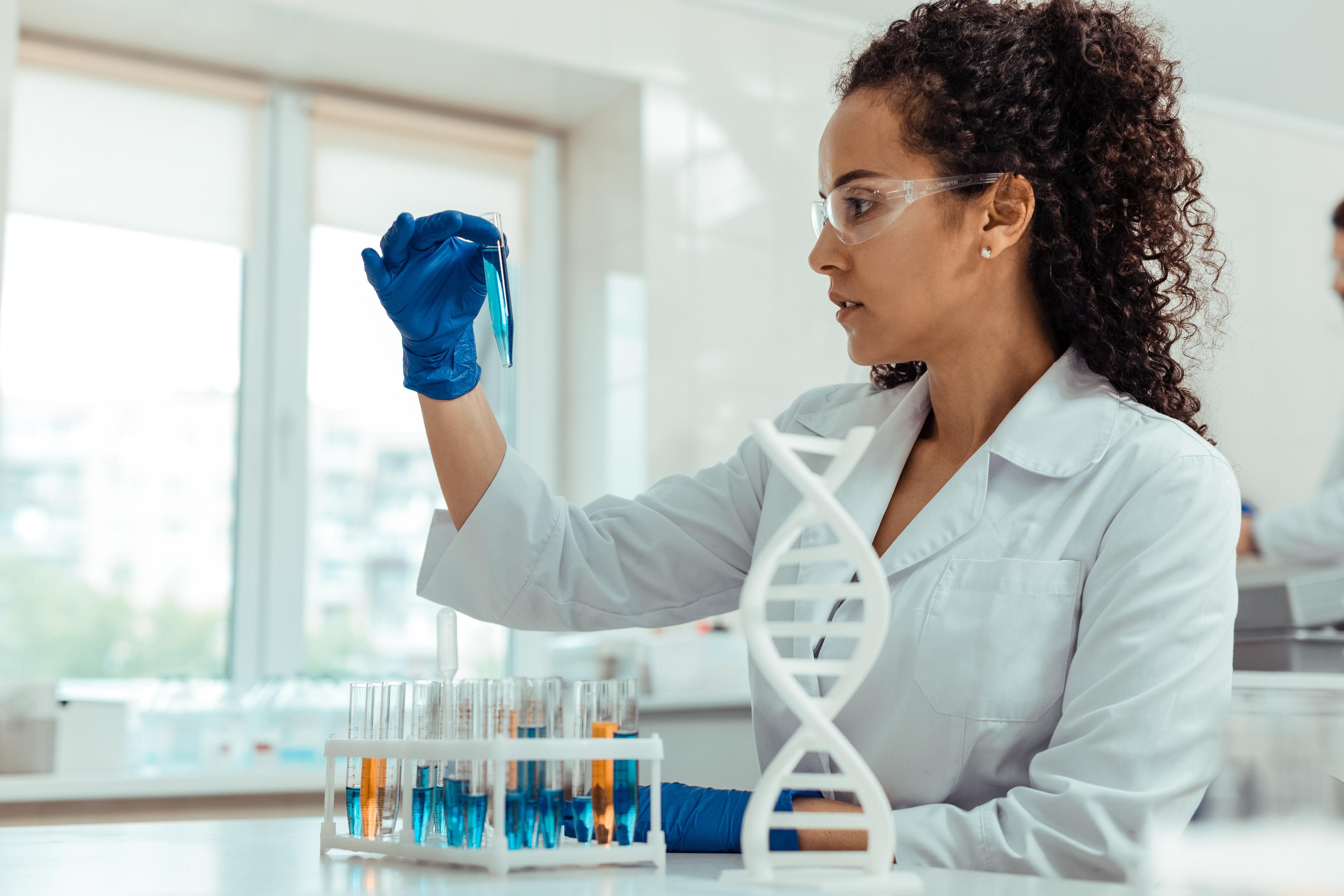 A scientist studies DNA, answering the question, is alcohol addiction genetic?